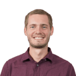 Portrait of a smiling man in burgundy shirt, transparent background.