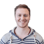 Headshot of a cheerful man in striped hoodie, clear background.