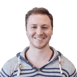 Headshot of a cheerful man in striped hoodie, clear background.