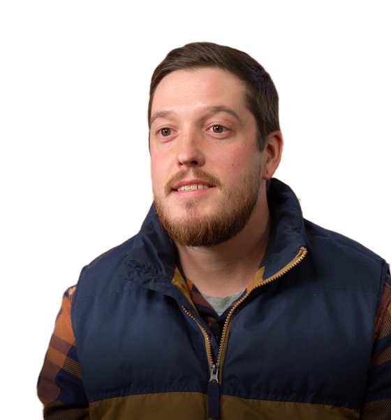 a man with a beard is wearing a blue vest